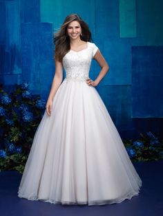 a woman in a white wedding dress posing for the camera