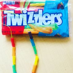 a bag of twizers sitting on top of a table next to a candy bar