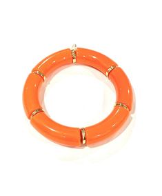 an orange bracelet on a white background