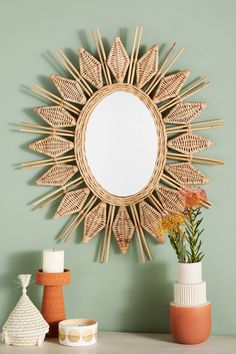 a mirror and some vases on a table