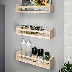 two wooden shelves with spices and condiments on them