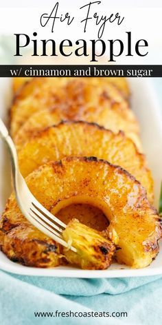 grilled pineapple with cinnamon and brown sugar on a white plate next to a fork