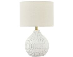 a white table lamp with a beige shade on the base and a gold trimming