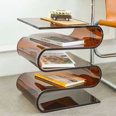 a glass shelf with books on top of it