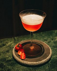 a drink in a glass sitting on top of a table