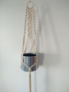 a hanging planter with rope and pot holder