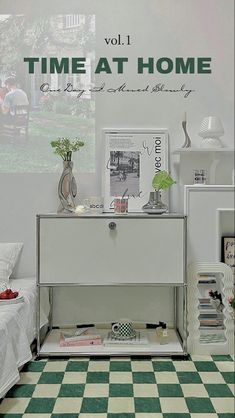 a white dresser sitting on top of a green and white checkered floor