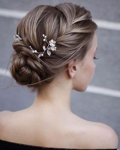 a woman wearing a hair comb with flowers in it