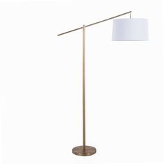 a floor lamp with a white shade on the base and a gold metal pole,