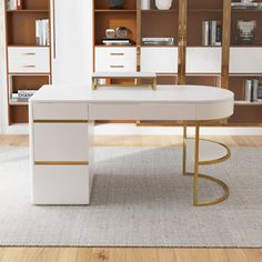 a white and gold desk in front of bookshelves