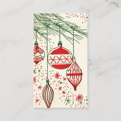 a christmas card with ornaments hanging from the tree