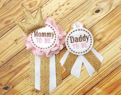 two pink and gold ribbons with the words mommy to be on them