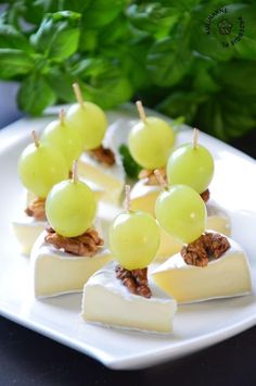 grapes and cheese are displayed on a plate