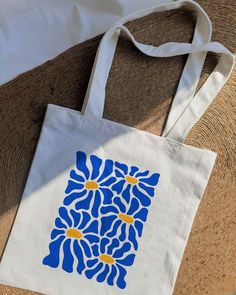 a white bag with blue and yellow flowers on it
