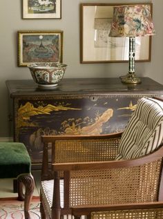 a living room filled with furniture and pictures on the wall above it's dresser