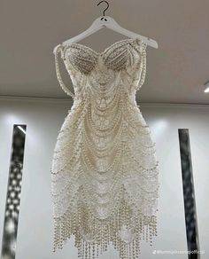 a dress hanging on a hanger in a room