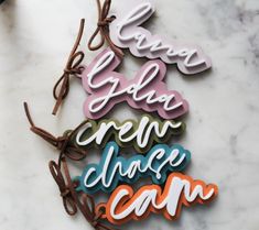 some type of magnets that are on a marble counter top with the words glam and creat above them