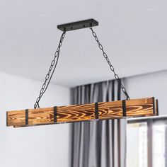 a wooden light fixture hanging from a ceiling