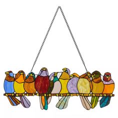 a stained glass bird hanging from a chain