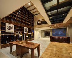 a large room with wooden shelves filled with books