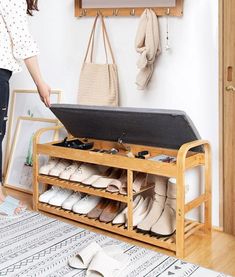 a woman standing next to a shoe rack filled with shoes