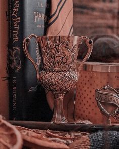 a golden trophy sitting on top of a table next to books