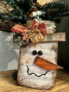 a wooden block with a snowman face on it