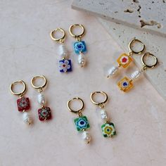 six different colored charms sitting on top of a table