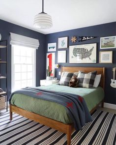 a bed room with a neatly made bed and pictures on the wall