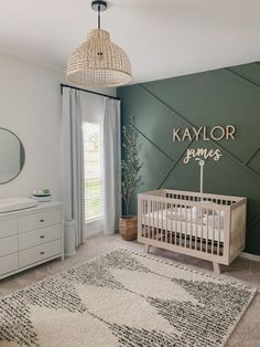 a baby's room with a crib, dresser and rug in the corner
