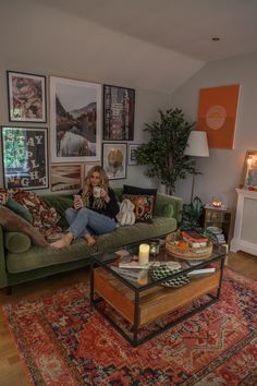 a woman sitting on top of a couch in a living room