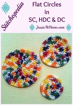 three crocheted buttons with the words, stitched circles in different colors and sizes