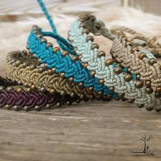 three bracelets sitting on top of a wooden table