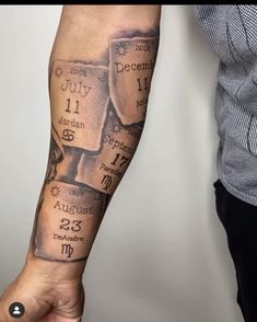 a person with a tattoo on their arm holding up a hand that has the names of two people