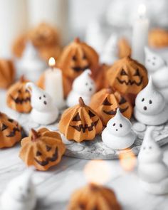 small pumpkins with faces carved into them on a table