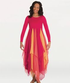 a woman in a pink and orange dress is smiling at the camera with her hands on her hips