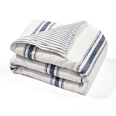 two blue and white striped pillows stacked on top of each other, one folded up