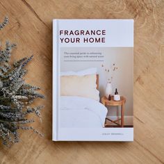 a book about how to decorate with lavender flowers on a table next to a bed