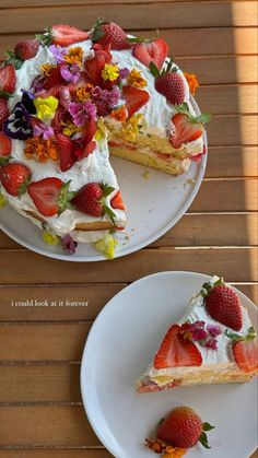 two slices of cake with strawberries and flowers on the top one slice is missing