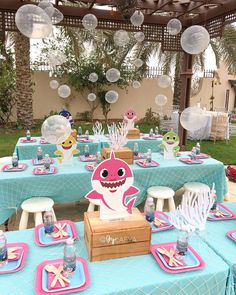 a table set up for a baby shark birthday party