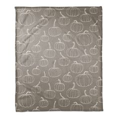 a gray and white blanket with pumpkins on the front, in an allover pattern