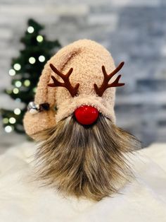 a close up of a stuffed animal with reindeer's nose and antlers on it