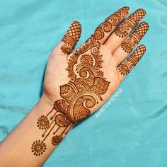 the hand is decorated with henna designs on it