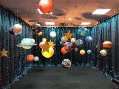 an office cubicle decorated with balloons and stars