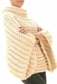 a woman is wearing a crocheted shawl