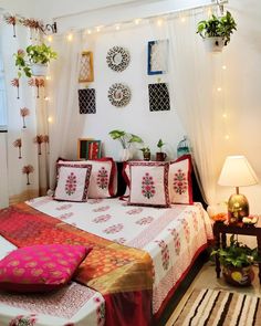 a bed room with a neatly made bed and lots of decorations on the wall above it