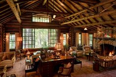 a living room filled with furniture and a fire place in the middle of a room