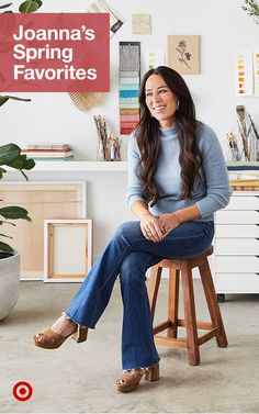 a woman sitting on top of a wooden stool