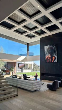 a large living room with high ceilings and modern furniture