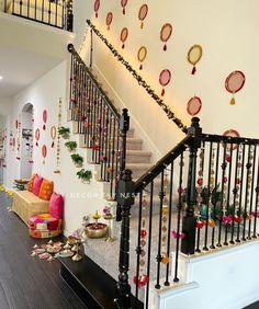 the stairs are decorated with festive garlands and ornaments on them, along with other decorations